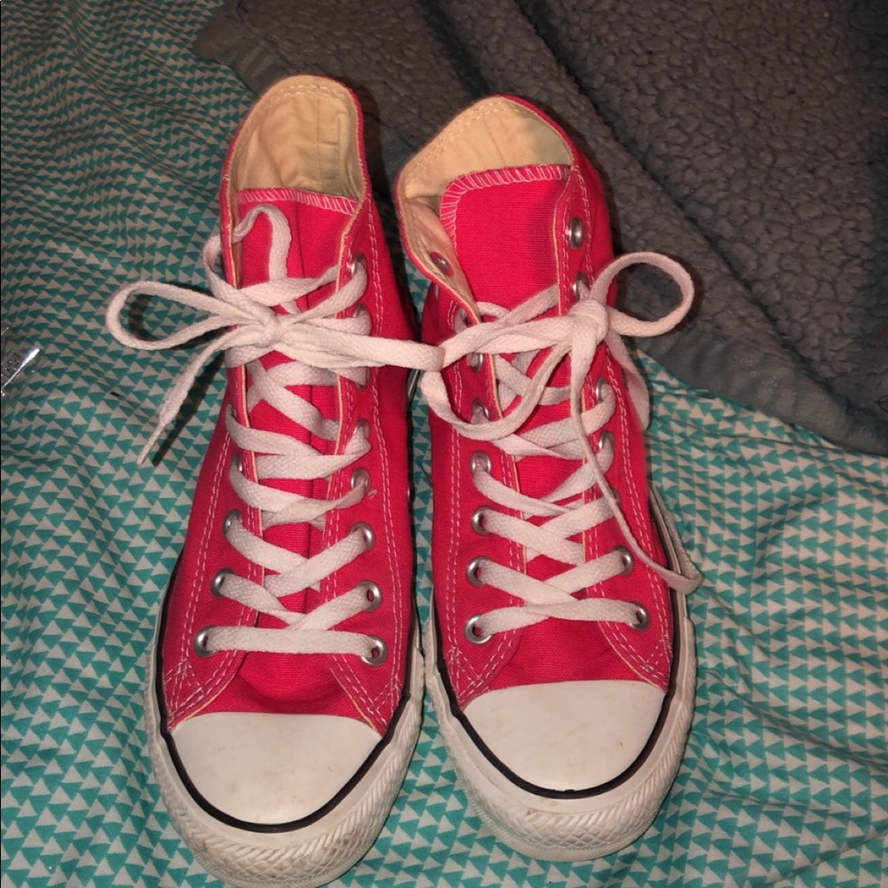 Hot pink hightop converse.